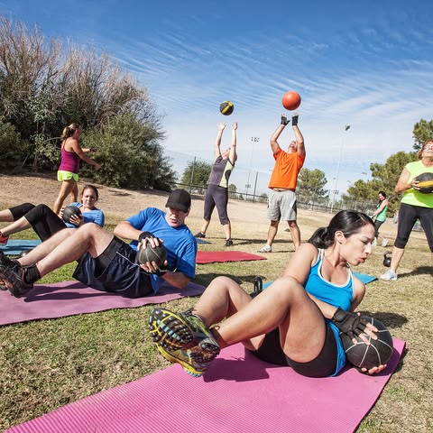 Participants in an outdoor fitness workshop among Finnish forest trees